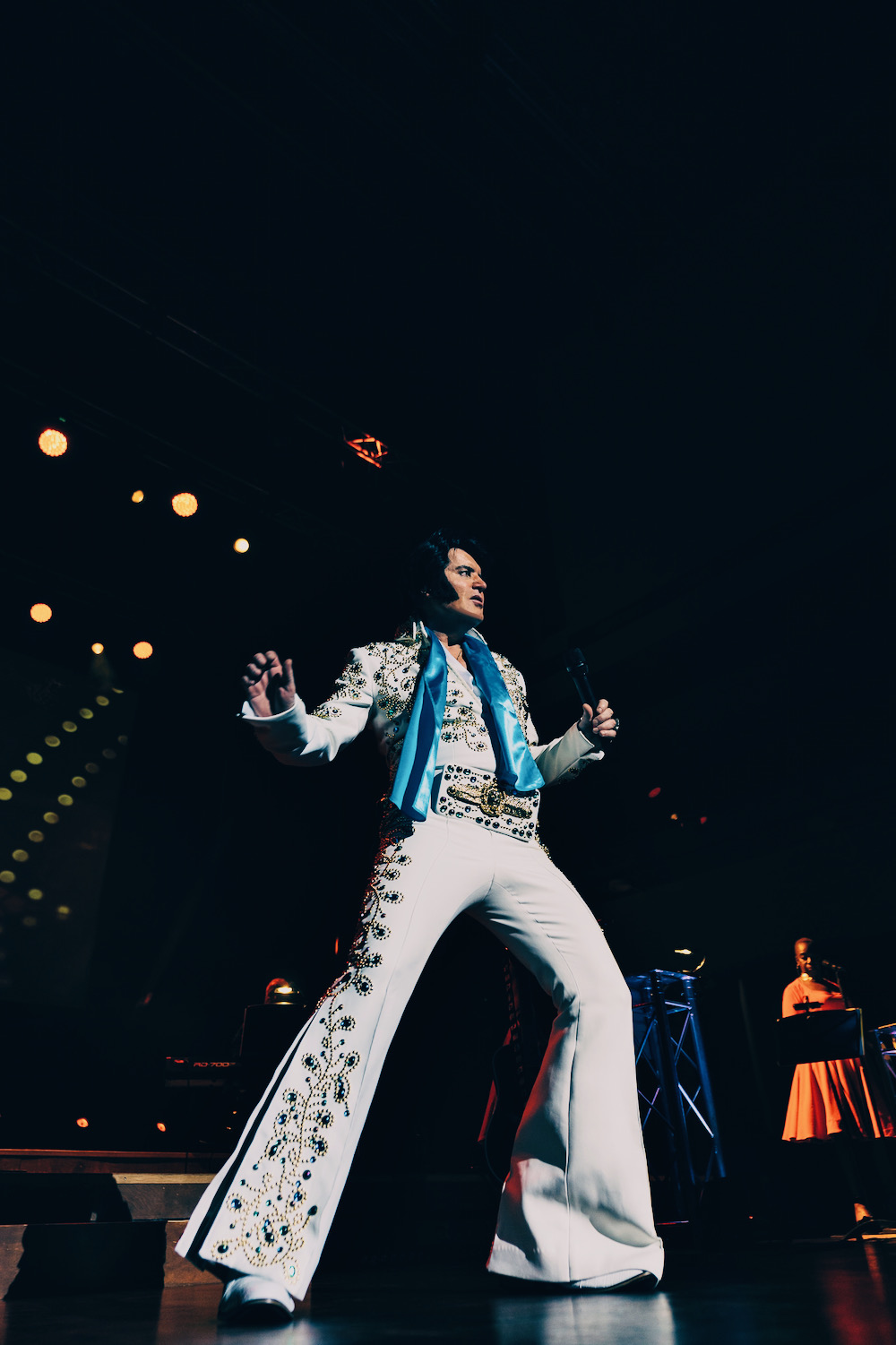 Rob Kingsley performing A Vision of Elvis live on stage in the Spanish Flower Elvis suit with blue scarf