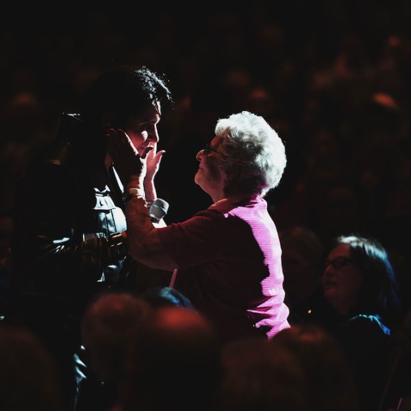 Rob Kingsley meeting an audience member during an A Vision of Elvis live performance